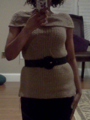 Selfie of me wearing a beige off-the-shoulder crochet sweater, cinched at the waist with a black belt.